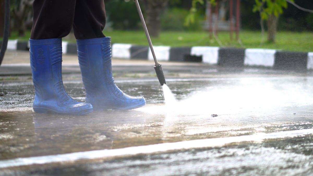 Close-up of a jet spray washing exterior pavement